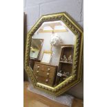 An octagonal gilt framed mirror.