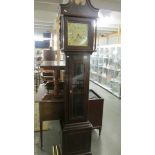 A modern Grandfather clock with brass dial.