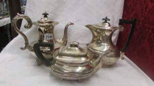 Two silver plate coffee pots and a silver plate teapot.