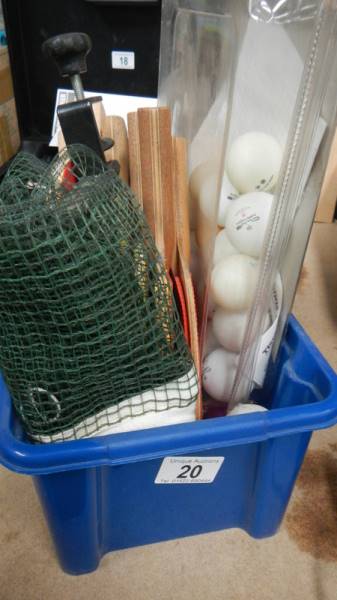 A box of table tennis items including net, balls, bats etc.