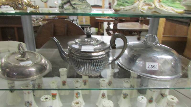 A silver plate teapot, meat cover and tureen lid.