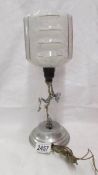 An art deco chrome figurine table lamp complete with shade.