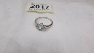 A diamond and topaz oval stone ring in a three stone design in 9ct white gold, size S.