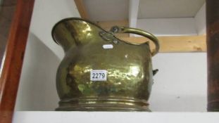 A brass coal scuttle.