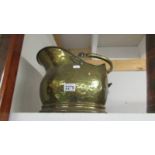 A brass coal scuttle.