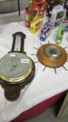 An oak barometer/thermometer in good condition together with another barometer (cracked glass)