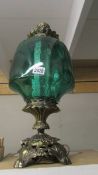 A large metal and green glass lamp.