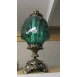 A large metal and green glass lamp.