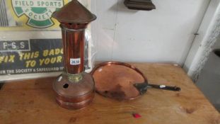 A copper stove and a copper sauce pan lid.