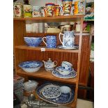 Four shelves of sundry items including blue and white china, mincers etc.