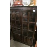A dark oak book case with glazed doors (collect only)