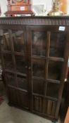 A dark oak book case with glazed doors (collect only)