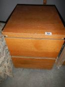 A two drawer filing cabinet.