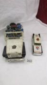 A large tin late battery operated police jeep a/f and one other.