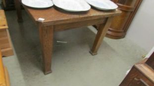 A heavy oak extending dining table.