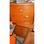 A pair of teak bedside cabinets.