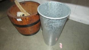 A coopered log bucket and a metal flower vase.