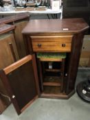 A dark wood stained cupboard with drawer & stool