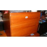 A teak two drawer chest.