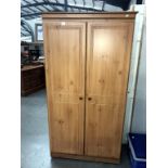 A pine effect 2 door wardrobe,