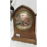 A mahogany inlaid 8 day mantel clock.