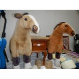 Two stuffed horses and a stool.