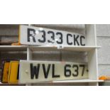 A quantity of car number plates.