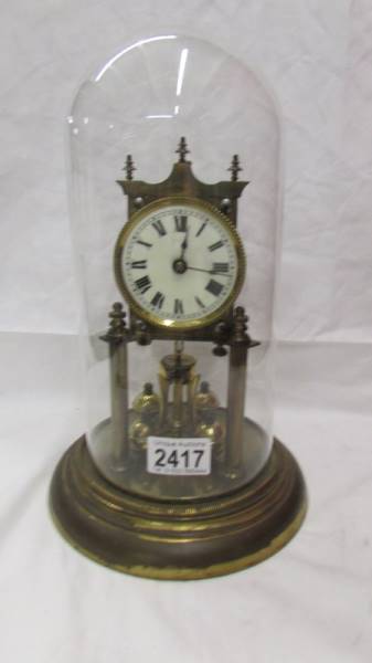 A 1908 Jahresuhren Fabrik anniversary clock under glass dome, no key.