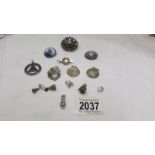 A silver 'Delft' brooch, a silver blood doner badge, a silver medallion, three silver fobs,