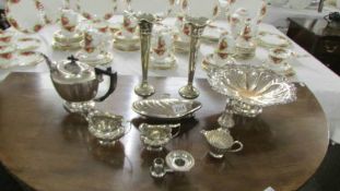 A mixed lot of silver plate including teapot, spill vases, etc.