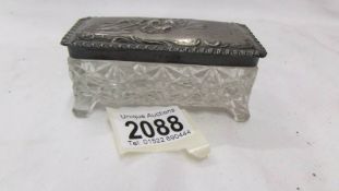 A silver topped cut glass trinket box.