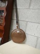 A Victorian copper warming pan.