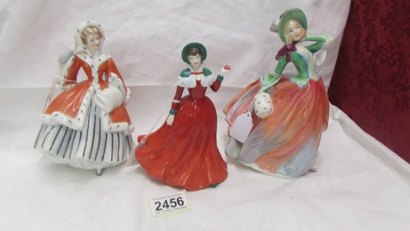 3 Royal Doulton figurines - Winter's Day HN 4589, Autumn Breezes HN 1911 and Noelle HN 2179.