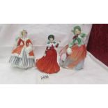 3 Royal Doulton figurines - Winter's Day HN 4589, Autumn Breezes HN 1911 and Noelle HN 2179.