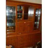 A teak effect glazed cabinet.