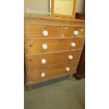 A two over three pine chest of drawers.