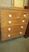 A two over three pine chest of drawers.