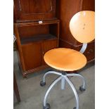 A small side cupboard and a pine chair on castors.