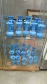 Approximately 30 blue glass vases in various styles, (2 shelves). (Collect only).