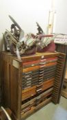 Two antique printing presses and a large chest of type.