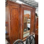 A Victorian mahogany break front wardrobe with fully fitted interior.