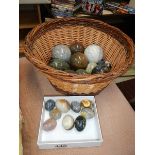 A collection of marble and stone eggs.