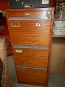 A three drawer filing cabinet.