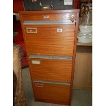 A three drawer filing cabinet.