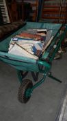 A Garden Tidy fabric wheel barrow full of books.