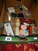 A box of miscellaneous items including Avon jewellery items, badges, harmonica etc.