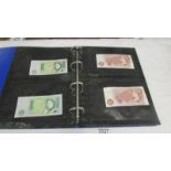 An album of bank notes including UK £1, UK 10/-, USA, Japan, Germany, France, Malaya etc.