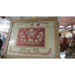 A framed and glazed embroidery commemorating South Africa 1899 - 1902.