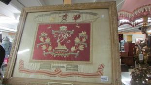 A framed and glazed embroidery commemorating South Africa 1899 - 1902.