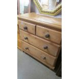 A two over two pine chest of drawers.